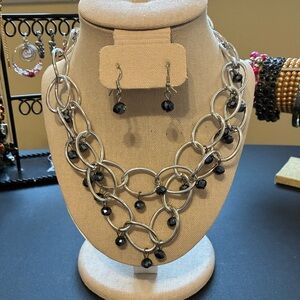 Silver-tone chain link necklace and dangling black bead earrings set.